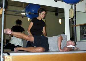 Photo: Pilates Instructor teaching a client the sidelying hip abduction series.