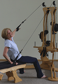 Elita, hand to bench, Gyrotonic Pulley Tower